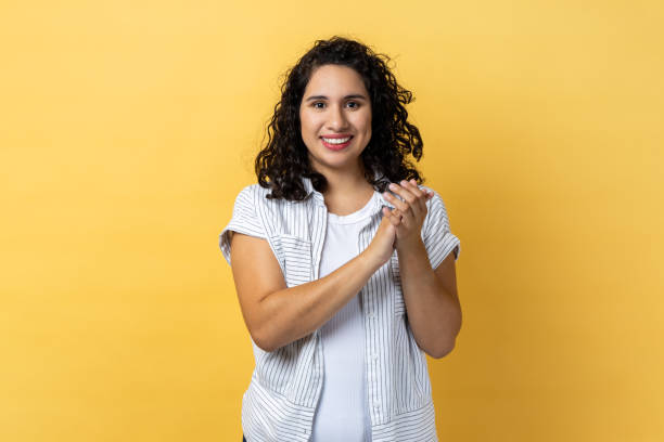 istock Delighted satisfied woman standing looking at camera with toothy smile, clapping hands. 2001251715