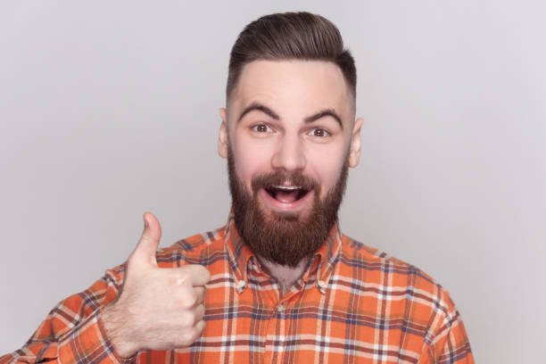 istock Excited positive man looking at camera with amazed expression, showing like gesture, thumb up. 2001284700