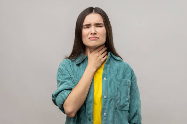 istock Sick dark haired woman touching sore neck feeling unwell, suffering tonsils inflammation. 2001294326