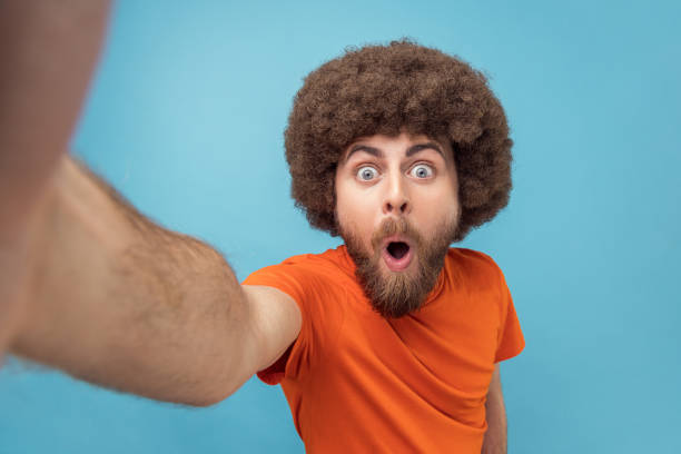 istock Man taking selfie or broadcasting livestream, looking with wow expression, POV. 2001294862