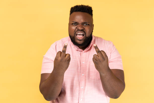 istock Man showing middle fingers and asking to get off expressing negativity, disrespectful behaviour. 2001294879