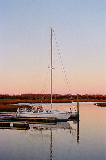 Sailboat docked during sunset