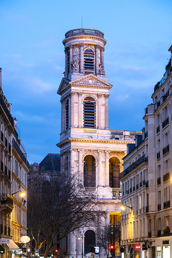 View on a tower of Saint Sulpice church, at dusk, in Saint Germain des Près, in Paris.