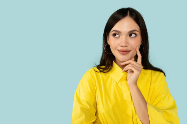 istock Curious young woman looking at copy space 2001376900