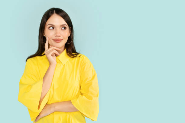 istock Curious young brunette woman looking at copy space 2001377428