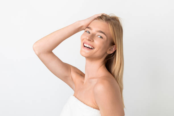 istock Attractive blonde young lady touching her hair and head, studio 2001377456