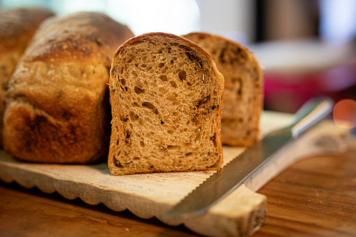 Wholegrain rye bread slice isolated on white background, full depth of field