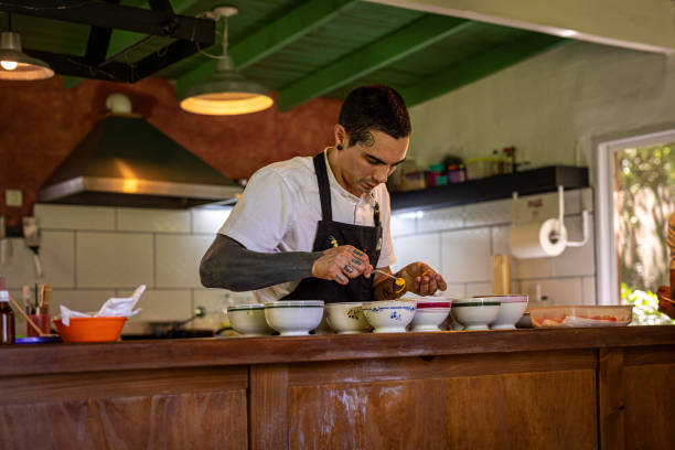 Skilled latin chef expertly grills tortillas in a bustling taco shop kitchen at night, creating mouthwatering tacos for hungry customers