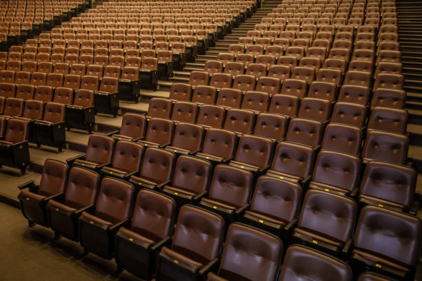 Theater or cinema auditorium with empty padded seats