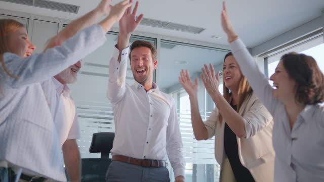 Happy employees team celebrating success together and applauding