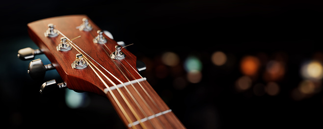 Close-up view of the strings and a sound hole of a guitar