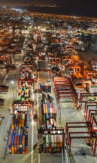 View of dock and containers in the port of Callao. Bulk and car carrier stay alongside the berth and have cargo operations