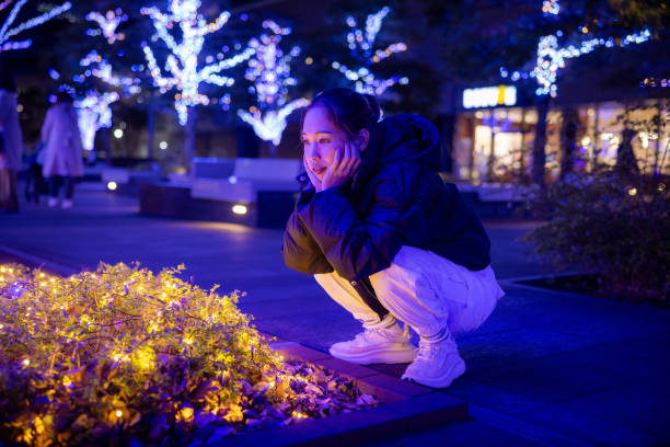 Female athlete looking at Christmas lights at night