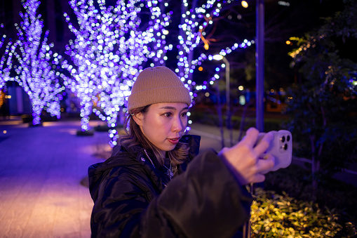 Female athlete taking selfie pictures on her way back home at night