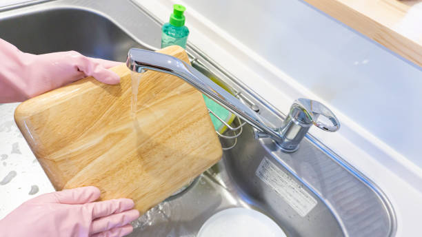 istock person washing dishes in the kitchen 2001500161