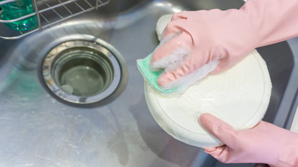 istock person washing dishes in the kitchen 2001503859