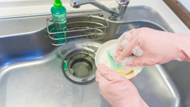 istock person washing dishes in the kitchen 2001504889