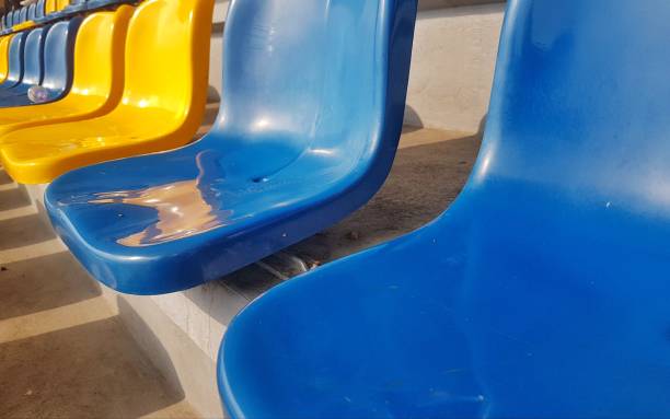 A pair of yellow and  red chairs isolated sandy beach on a background, taken with photo film and a retro styling