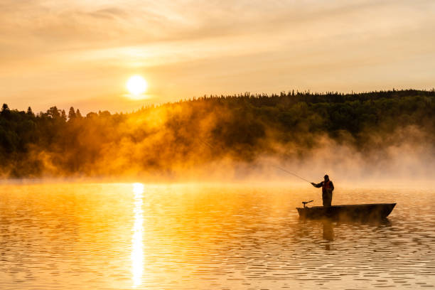 A senior man fishing at sunrise.