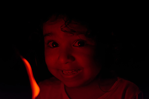 Girl going to sleep in bed happy and safe with her beloved stuffed animal that has red light and lullaby sound