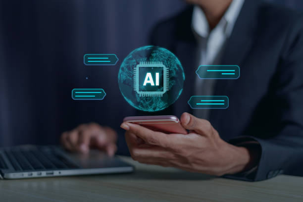 istock Businessman working on laptop revealing global data and email on smartphone screen Chatbot Chat with AI, Artificial Intelligence. man using technology smart robot AI, artificial intelligence by enter command prompt for generates something, Futuristic tech 2001621550