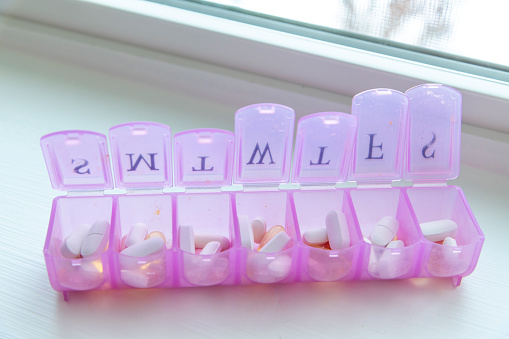 A full pill box or vitamin organizer with the days of the week separated individually to help remind when medication should be taken.
