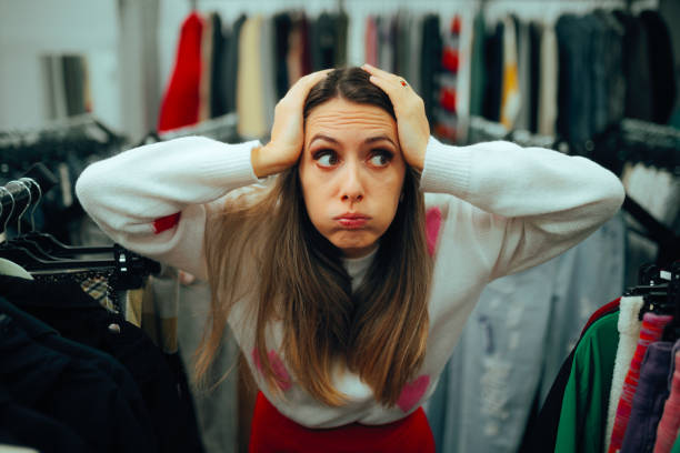 istock Puzzled Customer Trying to Decide in a Fashion Store 2001700523