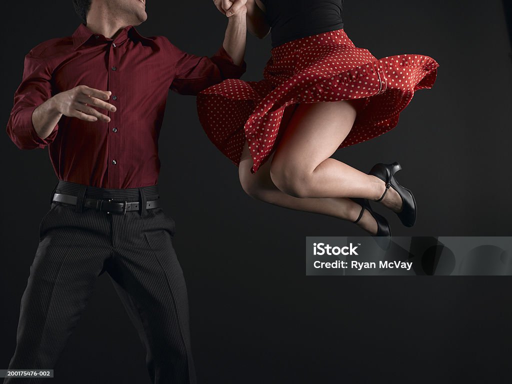 Couple swing dancing, low section  Swing Dancing Stock Photo