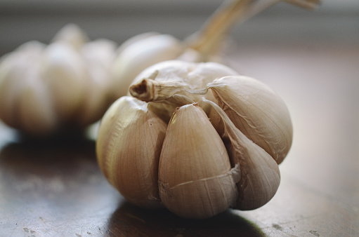 A supply of garlic on an empty shelf in the refrigerator. As a symbol of a decontaminating agent for the disease, the epidemic of coronavirus covid-2019. Funny photo.