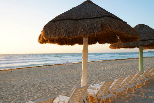 Wonderful view of sunset at Chaves beach. On the left a beach chair, in the center the setting sun, copy space, summer concept, Boa Vista island, Cape Verde.