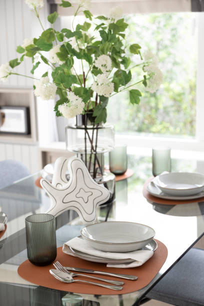 istock White and brown plate setting on dinning table in a dining room 2001810918