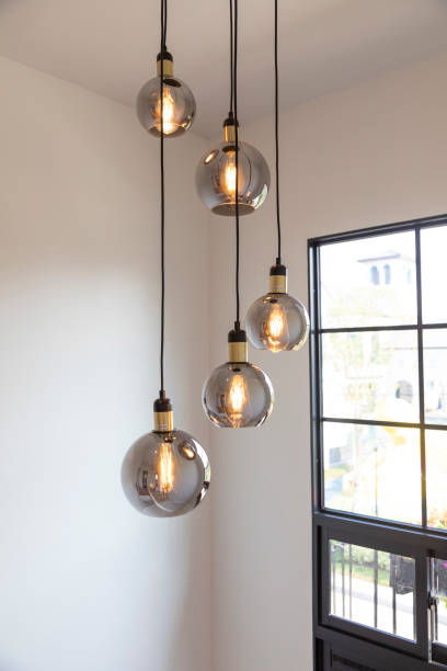 istock Modern round glass chandelier inside home staircase interior. 2001814570