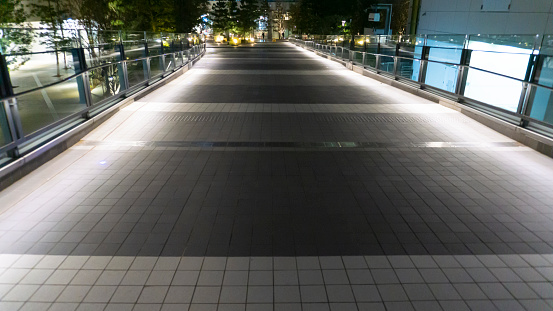 Footlights illuminating the footpaths on the sidewalk at night