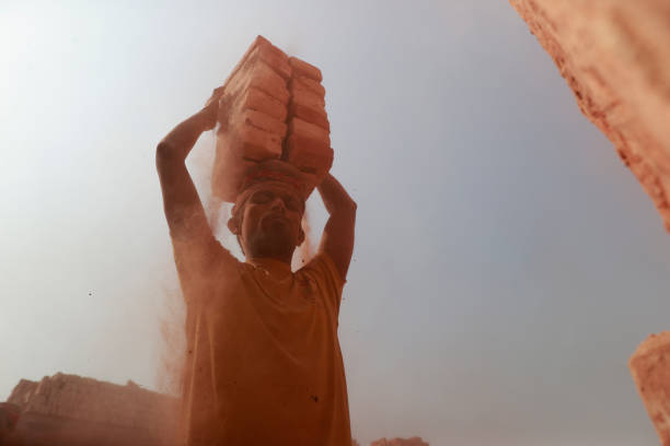 Bangladeshi men work at a brick field in Narayanganj, Bangladesh, February 10, 2024. Emission of huge quantity of toxic elements from brick kilns is causing serious health hazards to workers and people living in surrounding areas with most suffering from respiratory or skin problems. Workers in this brick field earn less than $5 a day. The environment is threatened by the toxic black smoke and waste of brick kilns, due to which the public health of the surrounding areas, rivers, and urban and rural areas is under serious threat. The elderly and children are the most affected by the pollution caused by brick kilns. Due to the black smoke of brick kilns, people's lung problems, respiratory problems, and various diseases related to the cold is increasing continuously.