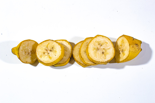 one large sliced banana served vertically on a plain white base