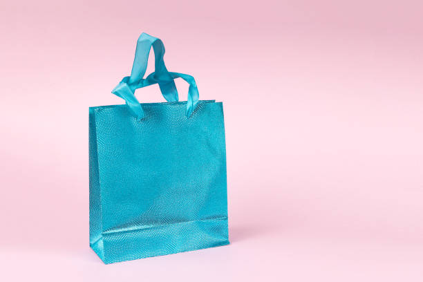 istock Beautiful blue gift bag on a pink background. 2001863604