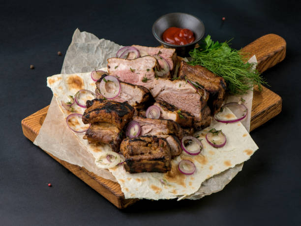 istock Assorted delicious grilled meat with vegetable. Mixed grilled meat with vegetables. Mixed grilled meat on wooden platter. Copyspace. 2001903350