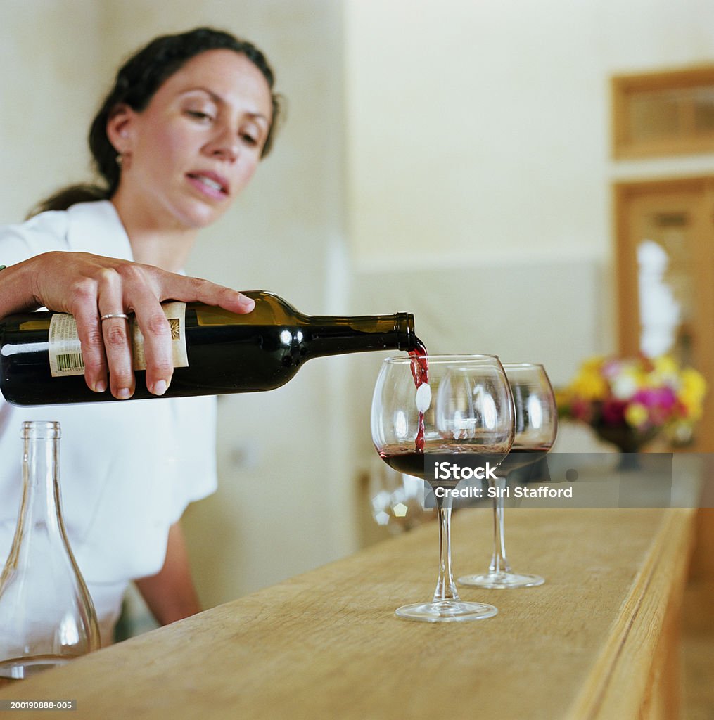 Bartender pouring wine into glass  Pouring Stock Photo