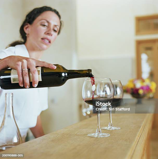 Bartender Pouring Wine Into Glass Stock Photo - Download Image Now - Pouring, Wine Tasting, Bartender