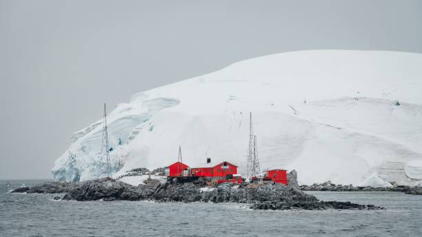 Antarctica Scientific Argentine Research Station King George Island Antarctica Scientific Research Station at the coast of King George Island in front of huge Glacier. Vibrant orange-red painted Research Station and Rescue Huts and Houses at the Coast towards the Antarctic Ocean, Dallmann Bay, King George Island - Melchior Islands, Antarctica houses in antarctica stock pictures, royalty-free photos & images