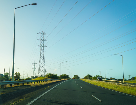 Transmission towers and power lines along the motorway. Auckland.
