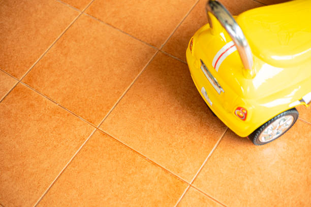 istock Yellow Toy Car Was Parked On The Tile Floor 2001947878