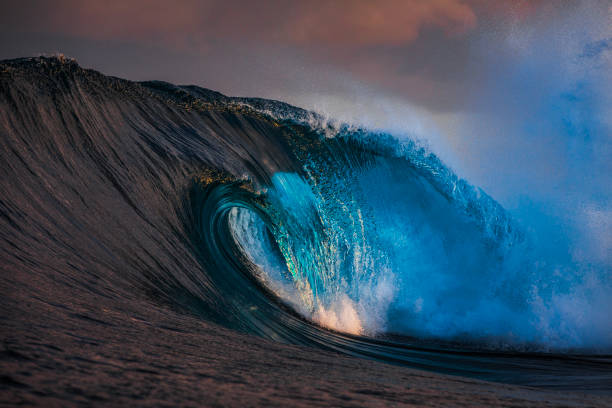 istock Powerful abstract wave breaking on reef in the ocean with soft golden light and dramatic sky 2001953620