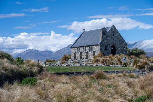 Experience the mesmerizing beauty of New Zealand's Church of the Good Shepherd under a blue sky. A celestial spectacle awaits.