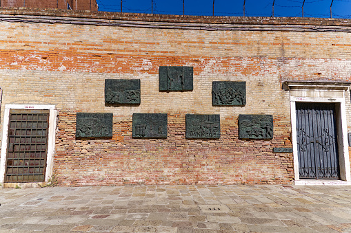 Old town of Venice with bronze holocaust memorial table at Ghetto Novo on a sunny summer day. Photo taken August 7th, 2023, Venice, Italy.