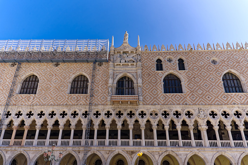 Looking up facade of Doge's Palace at Piazza san Marco with Doge's Palace and Cathedral at City of Venice on a sunny summer day. Photo taken August the 7th, 2023, Venice, Italy.