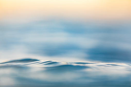 Surface texture of silky smooth soft ocean surface, shot at sunrise while swilling in the ocean of Western Australia.