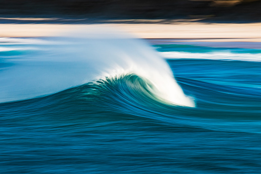 Slow shutter blur of smooth wave breaking on reef in the ocean. Shot off the south west coast of Australia.