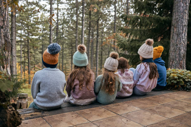 Happy kids enjoying cabin vacation in nature.