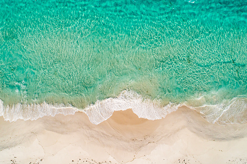 Directly above aerial view of beach and ocean shoreline with waves. Photographed in Western Australia.